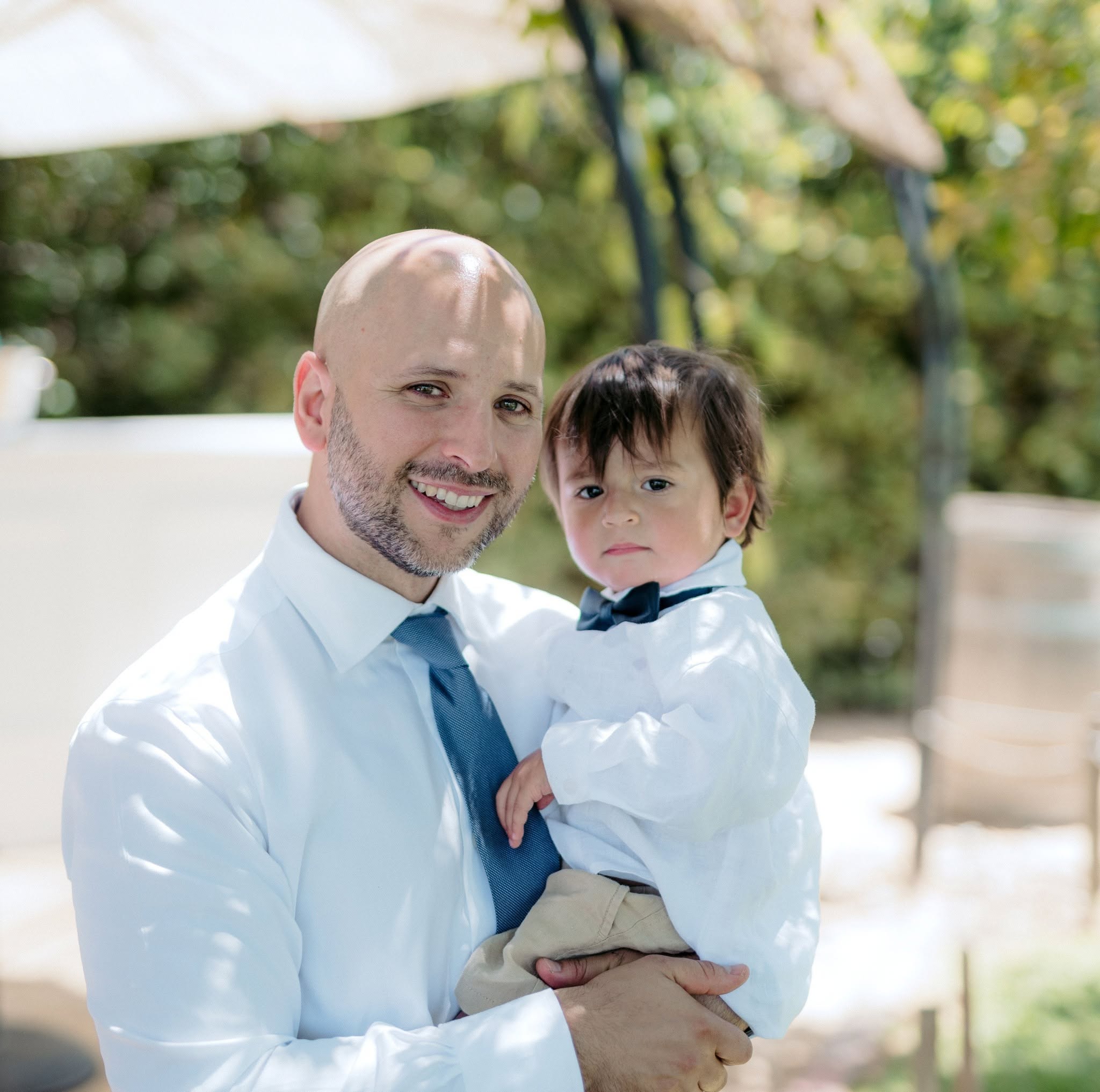 Matt Giglio holding his son outdoors.